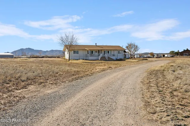 a view of big lake with houses in the background
