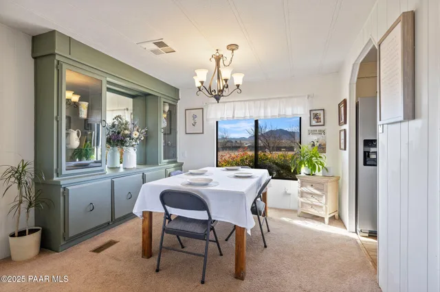 a view of a dining room with furniture window and outside view