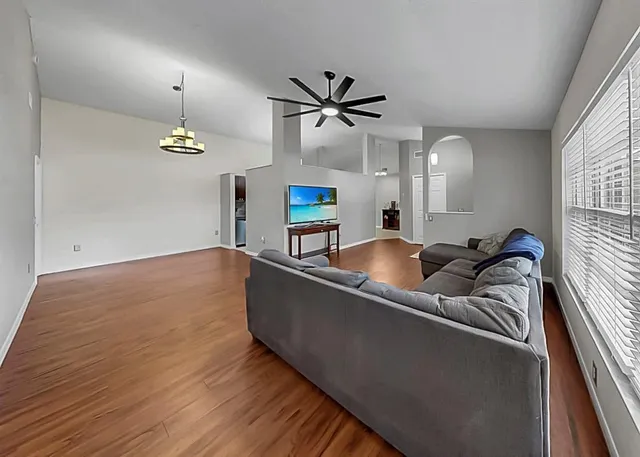 a living room with furniture and a chandelier