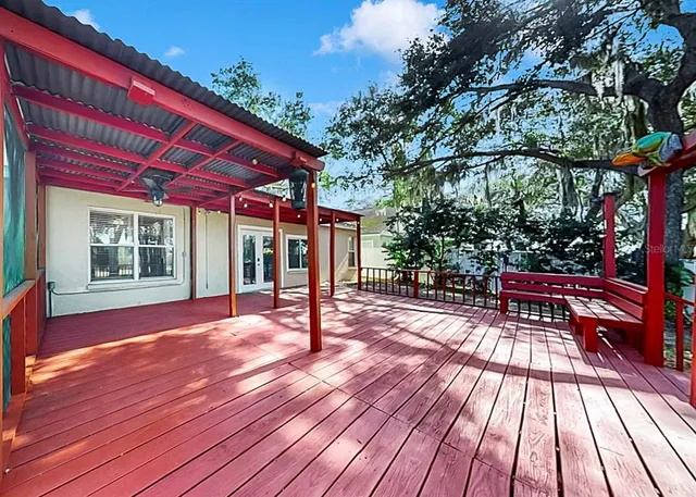 a view of a house with pool and wooden floor