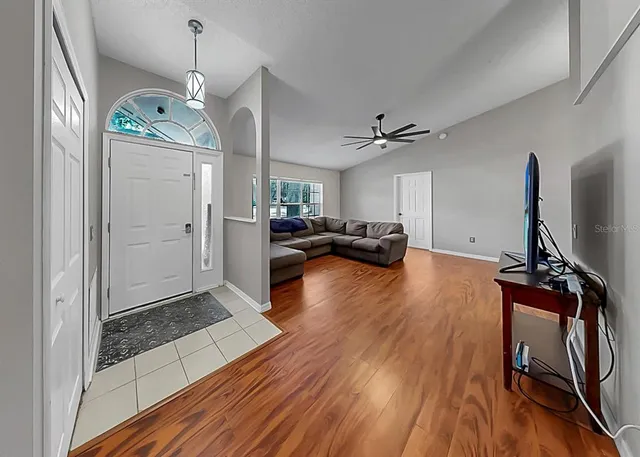 a view of a livingroom with furniture and a flat screen tv