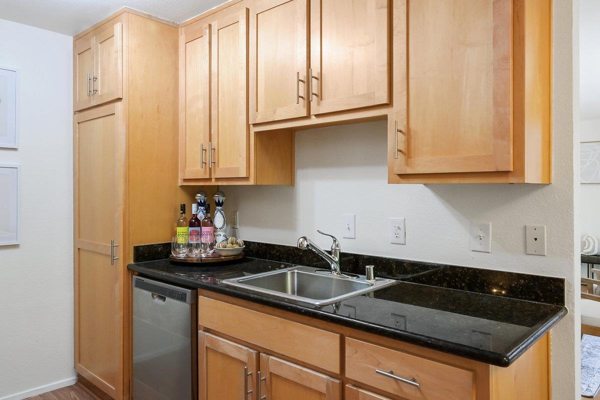 900 Cambridge Drive, Unit 181 Benicia, CA 94510 - Photo 11 of 38 a kitchen with granite countertop a sink a stove and cabinets