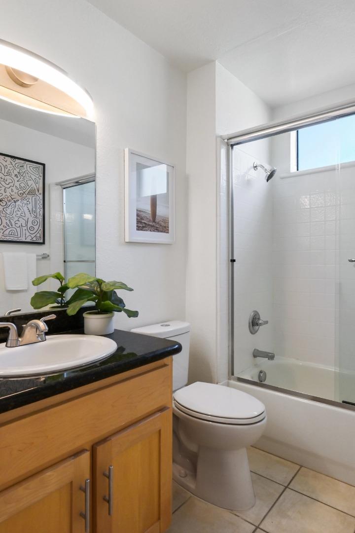 900 Cambridge Drive, Unit 181 Benicia, CA 94510 - Photo 16 of 38 a bathroom with a granite countertop sink a toilet and shower