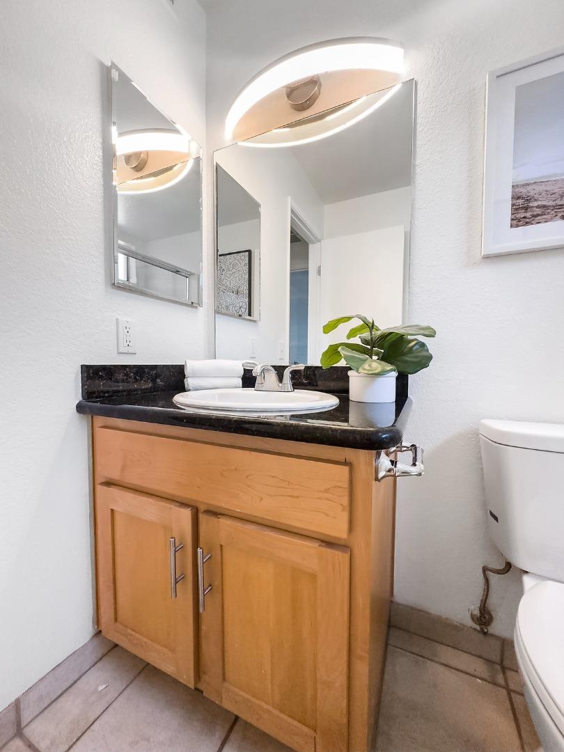900 Cambridge Drive, Unit 181 Benicia, CA 94510 - Photo 17 of 38 a bathroom with a sink mirror vanity and toilet
