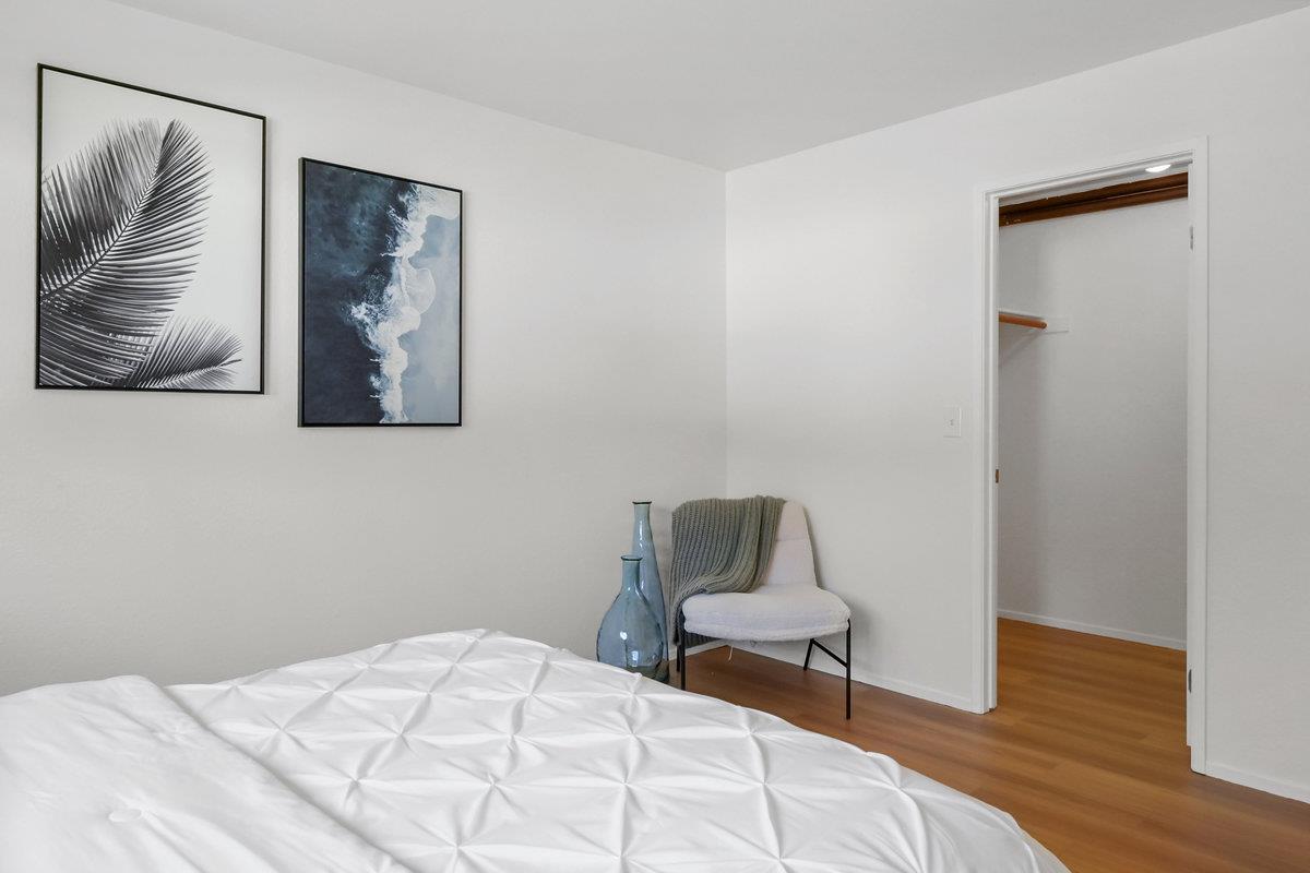 900 Cambridge Drive, Unit 181 Benicia, CA 94510 - Photo 28 of 38 a bedroom with a bed and wooden floor