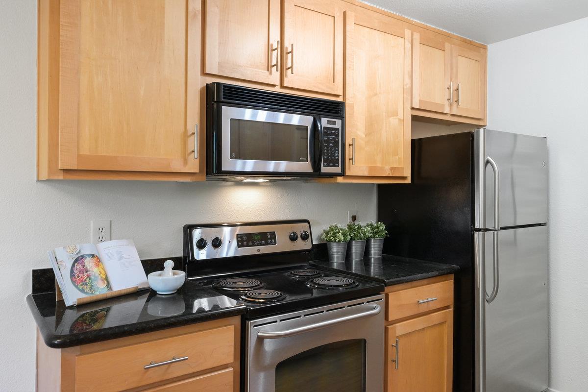 900 Cambridge Drive, Unit 181 Benicia, CA 94510 - Photo 10 of 38 a kitchen with granite countertop cabinets stainless steel appliances and a counter space