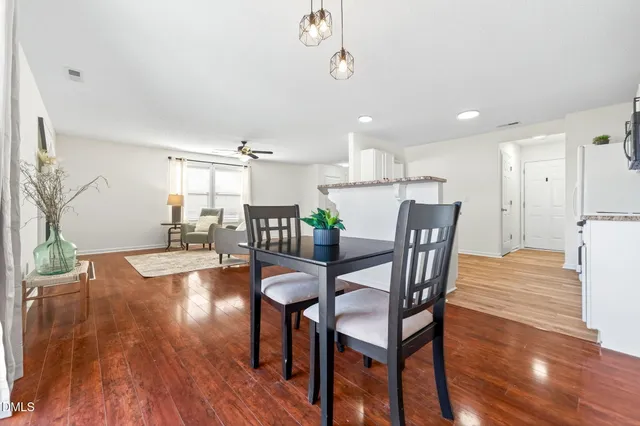 a view of a dining room with furniture and wooden floor