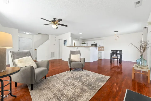 a living room with furniture and wooden floor