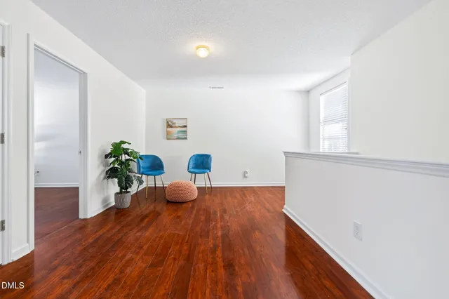 a room with wooden floor and furniture