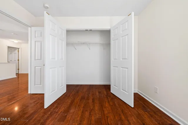 a view of a room with wooden floor