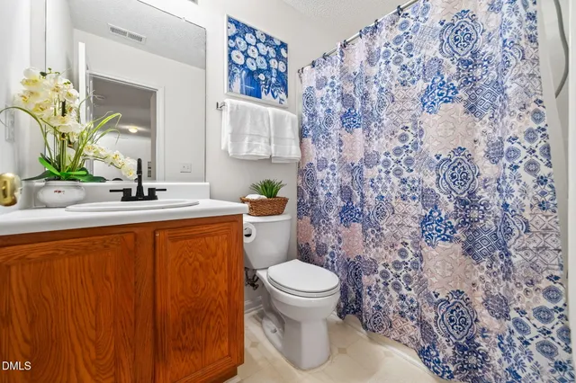 a bathroom with a sink toilet and mirror