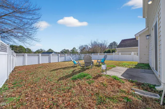 a view of a backyard with swimming pool