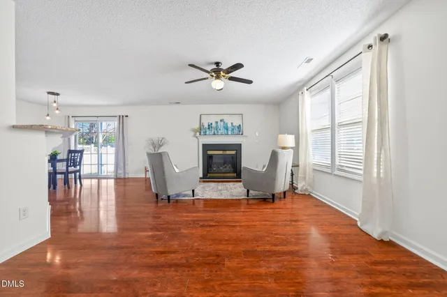 a view of a livingroom with furniture wooden floor and a window