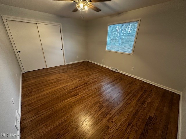 9109 Johnnycake Ridge Road Mentor, OH 44060 - Photo 17 of 28 Unfurnished bedroom featuring dark wood-style flooring, a ceiling fan, and a closet