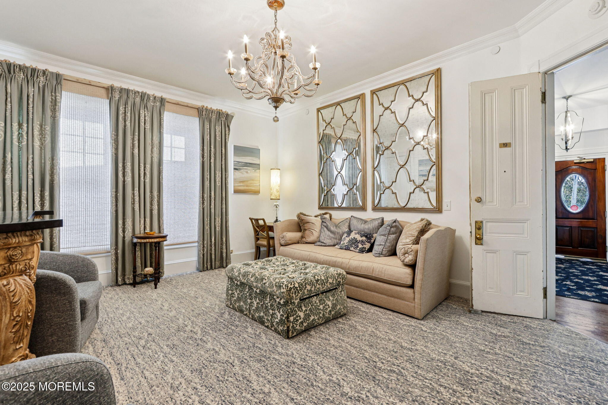 200 Monmouth Avenue, Unit 19 Spring Lake, NJ 07762 - Photo 5 of 28 a living room with furniture and a chandelier