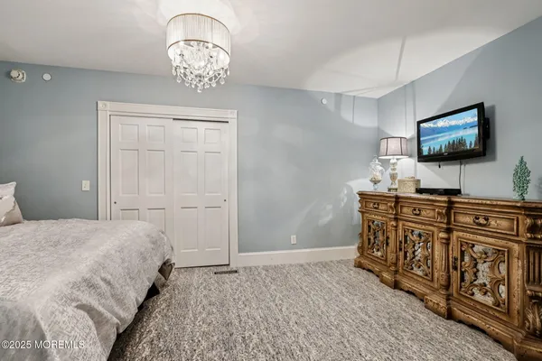a bedroom with a bed and flat screen tv