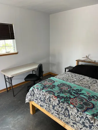 a bedroom with a bed and a chair