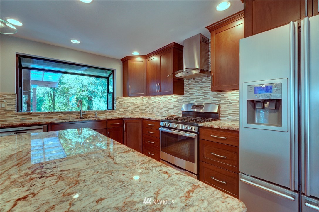 2831 Whitworth Avenue South Renton, WA 98055 - Photo 13 of 40 a kitchen with stainless steel appliances granite countertop a stove a sink and a refrigerator