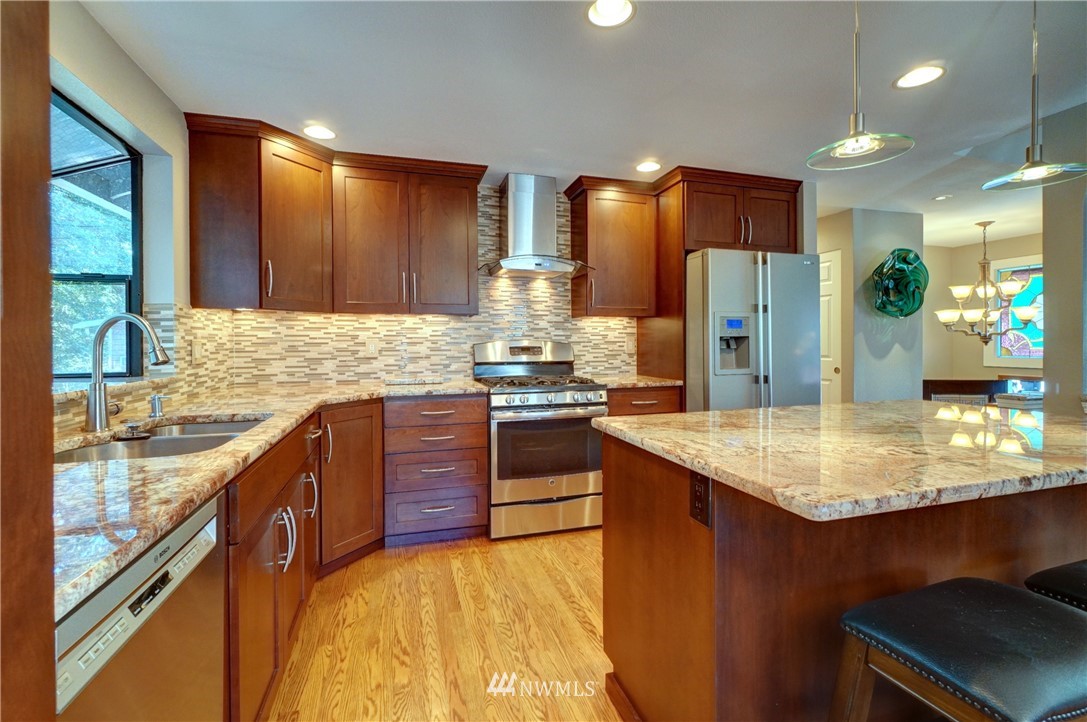 2831 Whitworth Avenue South Renton, WA 98055 - Photo 14 of 40 a kitchen with stainless steel appliances granite countertop a sink stove and refrigerator