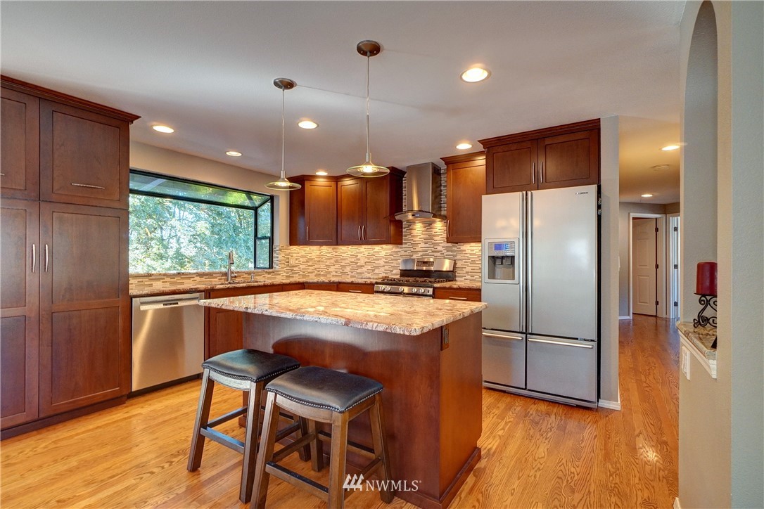 2831 Whitworth Avenue South Renton, WA 98055 - Photo 15 of 40 a kitchen with stainless steel appliances granite countertop a refrigerator a sink dishwasher a stove and a refrigerator with wooden floor