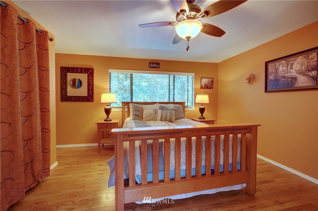 2831 Whitworth Avenue South Renton, WA 98055 - Photo 19 of 40 a bedroom with a bed and a chandelier
