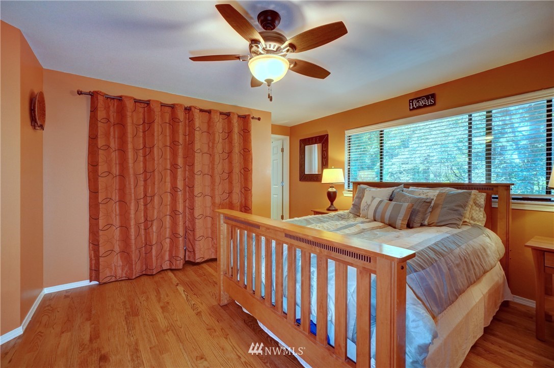 2831 Whitworth Avenue South Renton, WA 98055 - Photo 20 of 40 a bedroom with a bed and a large window with wooden floor