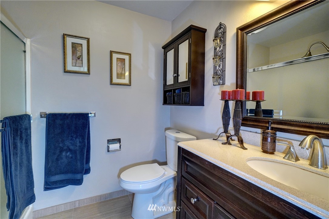 2831 Whitworth Avenue South Renton, WA 98055 - Photo 21 of 40 a bathroom with a sink a toilet and mirror
