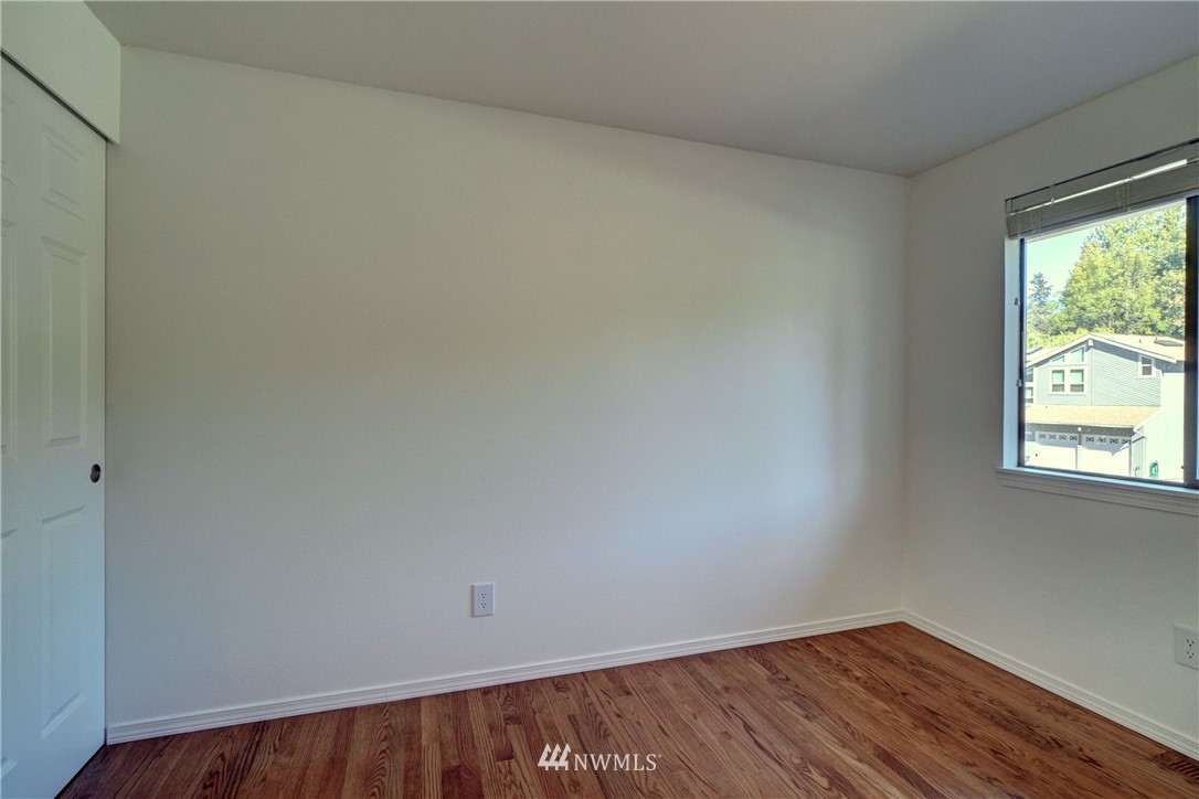 2831 Whitworth Avenue South Renton, WA 98055 - Photo 23 of 40 a view of an empty room with wooden floor and a window