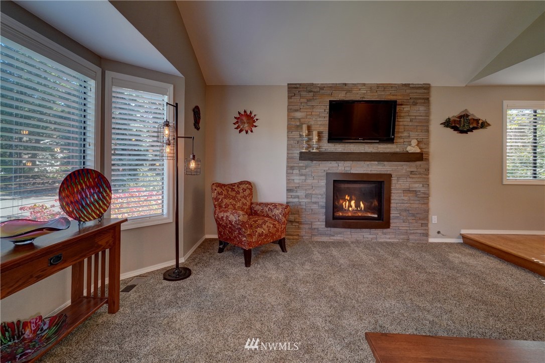 2831 Whitworth Avenue South Renton, WA 98055 - Photo 9 of 40 a living room with furniture a flat screen tv and a fireplace