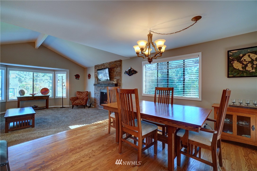 2831 Whitworth Avenue South Renton, WA 98055 - Photo 10 of 40 a view of a dining room with furniture a chandelier and wooden floor