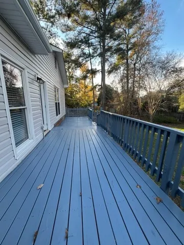 a view of deck with wooden floor and fence