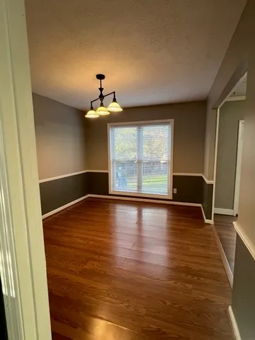 a view of room with window and wooden floor