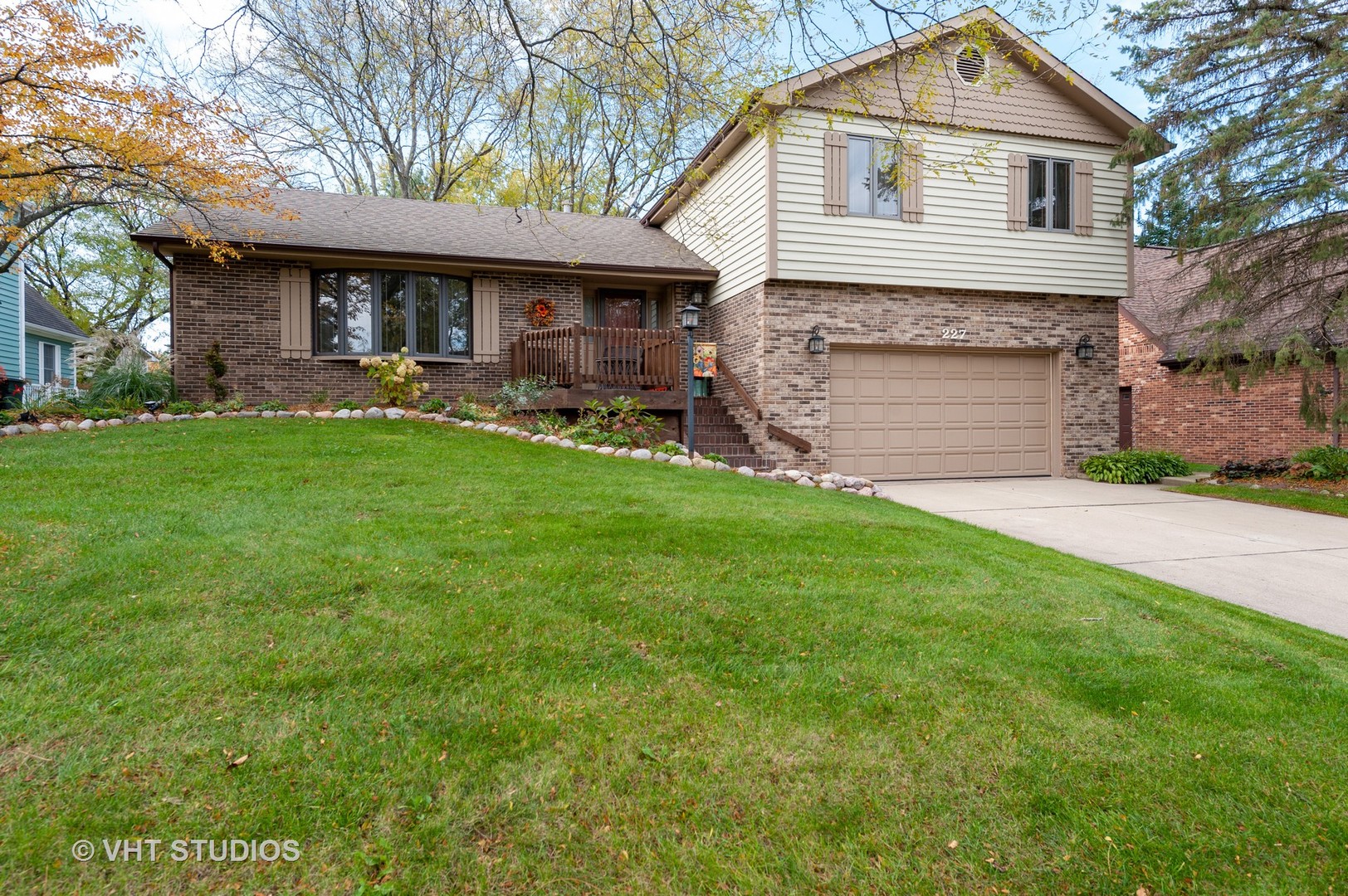 227 Perth Road Cary, IL 60013 - Photo 1 of 19 a front view of a house with a garden and yard