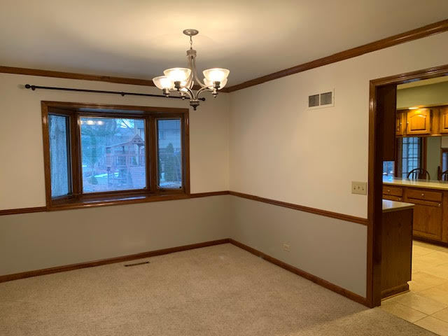227 Perth Road Cary, IL 60013 - Photo 10 of 19 a view of a livingroom with a chandelier fan and windows