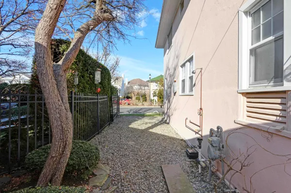 a view of a brick house with many windows next to a road