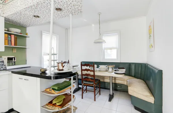 a kitchen with a table chairs stove and cabinets