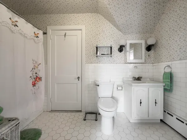 a bathroom with a toilet sink and shower