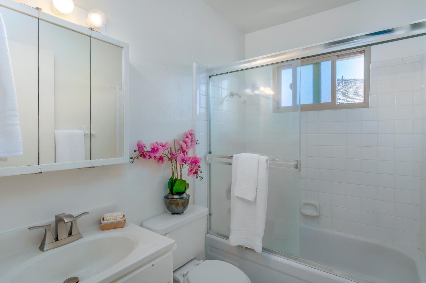 1375 Ruby Court, Unit 4 Capitola, CA 95010 - Photo 11 of 15 a bathroom with a sink mirror vanity and toilet