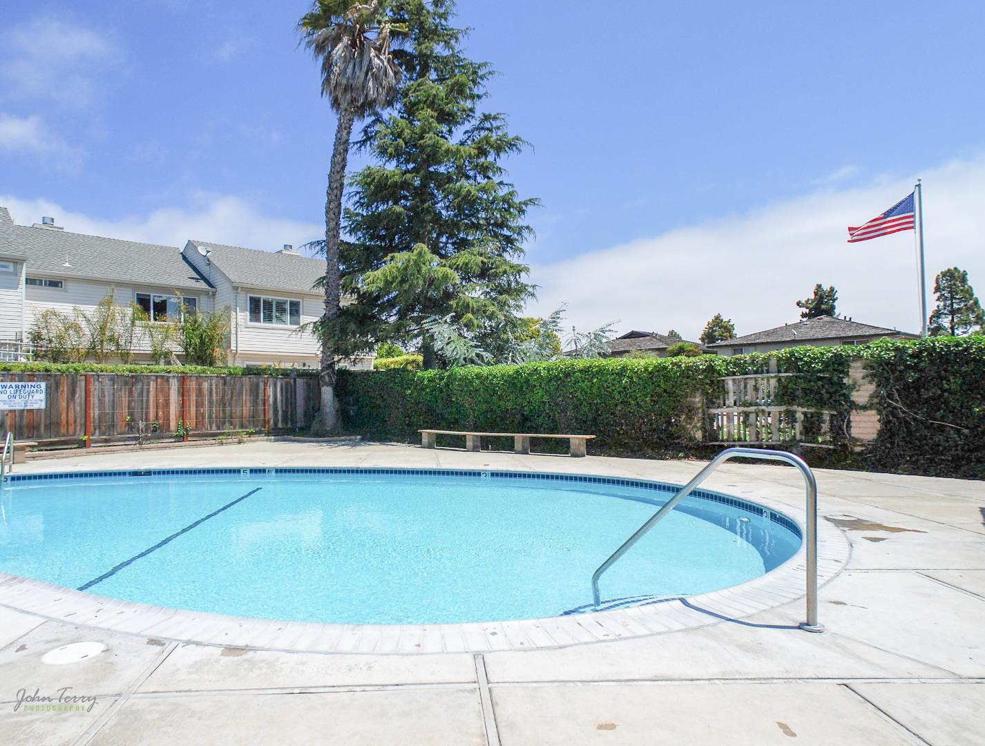 1375 Ruby Court, Unit 4 Capitola, CA 95010 - Photo 14 of 15 a view of a swimming pool with a lounge chairs