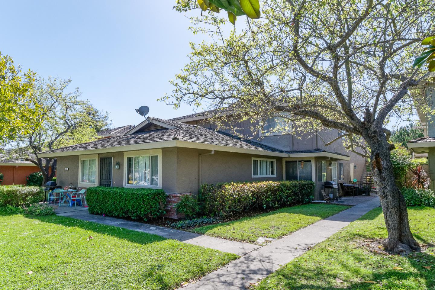 1375 Ruby Court, Unit 4 Capitola, CA 95010 - Photo 3 of 15 a view of house in front of a yard with potted plants and large trees