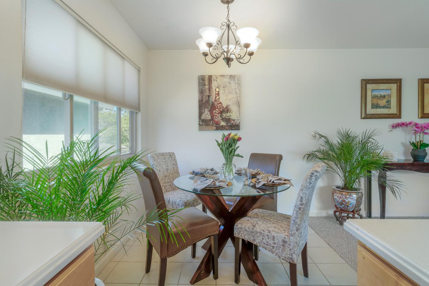 1375 Ruby Court, Unit 4 Capitola, CA 95010 - Photo 8 of 15 a dining room with furniture potted plants and wooden floor