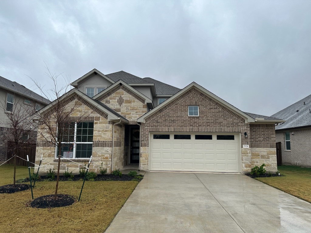 2124 Ridge Runner Drive Georgetown, TX 78628 - Photo 1 of 1 a front view of a house with garage