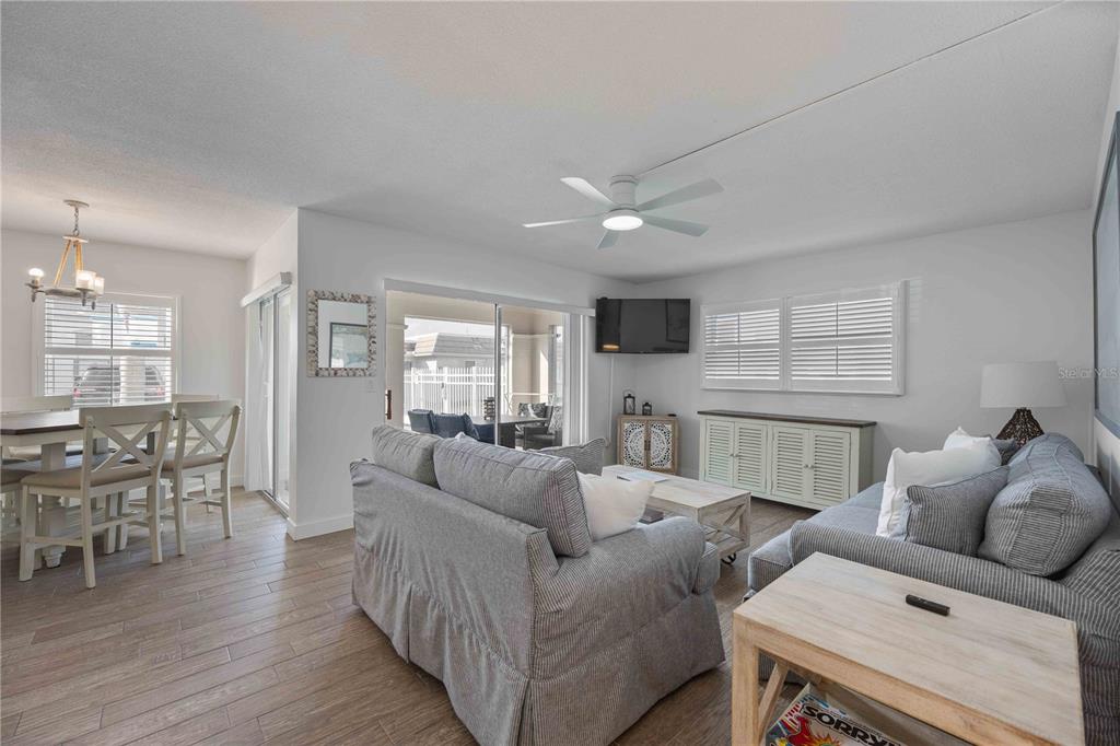 6150 Midnight Pass Road, Unit 10 A&B Sarasota, FL 34242 - Photo 12 of 65 a living room with furniture and wooden floor