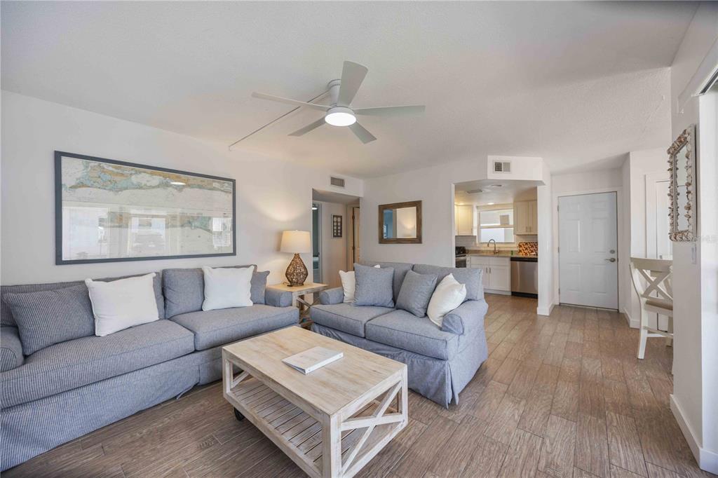 6150 Midnight Pass Road, Unit 10 A&B Sarasota, FL 34242 - Photo 14 of 65 a living room with furniture and a wooden floor