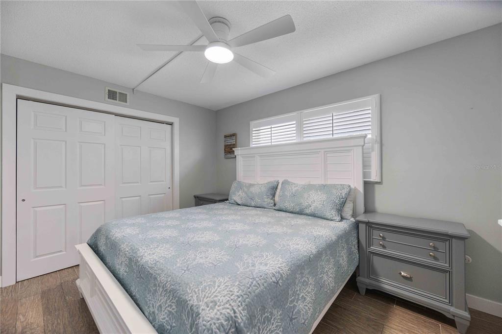6150 Midnight Pass Road, Unit 10 A&B Sarasota, FL 34242 - Photo 19 of 65 a bedroom with a bed and a ceiling fan
