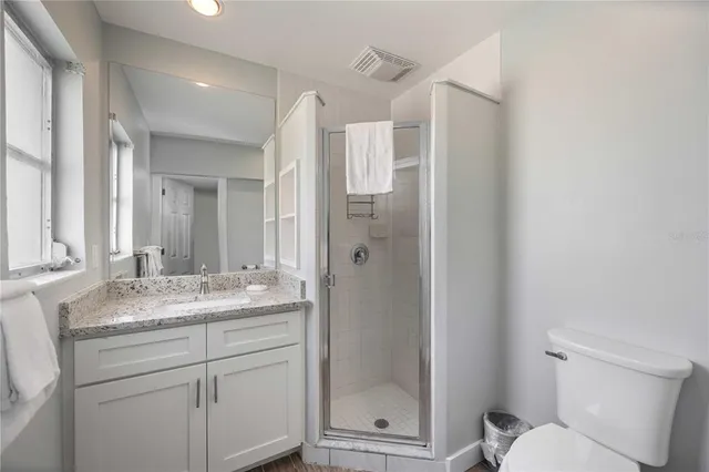 a living room with furniture wooden floor and a large window