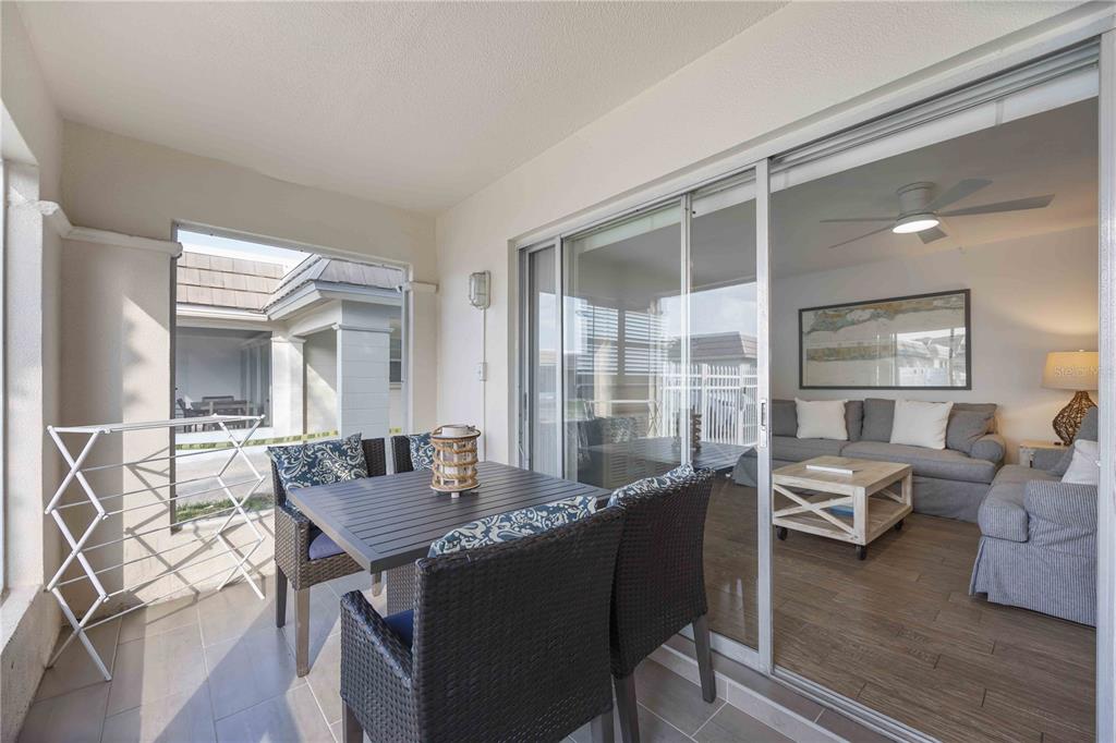 6150 Midnight Pass Road, Unit 10 A&B Sarasota, FL 34242 - Photo 26 of 65 a living room with furniture wooden floor and a large window
