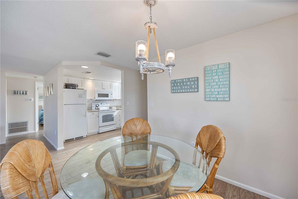 6150 Midnight Pass Road, Unit 10 A&B Sarasota, FL 34242 - Photo 29 of 65 a view of a dining room with furniture and wooden floor