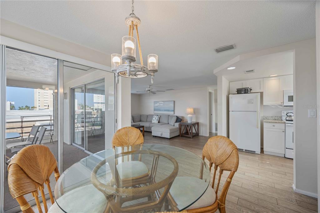 6150 Midnight Pass Road, Unit 10 A&B Sarasota, FL 34242 - Photo 30 of 65 a living room with furniture and a chandelier