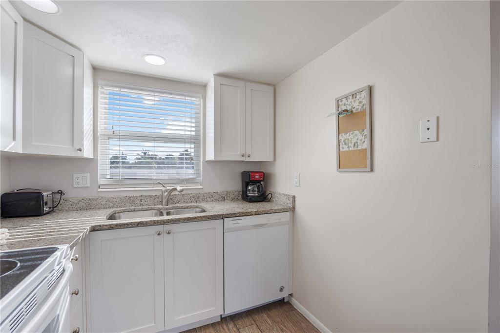6150 Midnight Pass Road, Unit 10 A&B Sarasota, FL 34242 - Photo 35 of 65 a kitchen with a sink cabinets and window